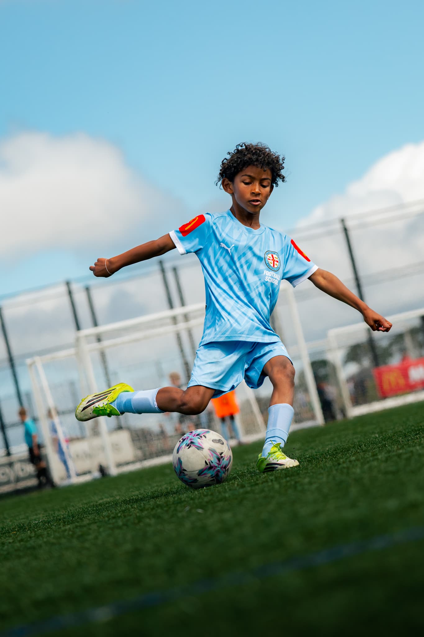 Young football player developing skills during training.